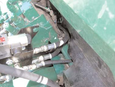 The right side steering hose should be routed over the top of the front drive line cover