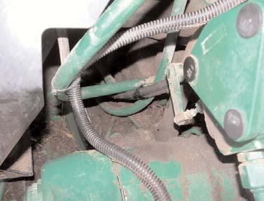 2) Route the hoses back inside the tractor frame on the left side, under the cab, and