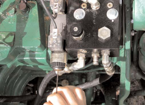 9. Install the Valve Control Cable: Route the valve control cable (R) through the cable grommet in the tractor window seal.