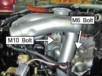 Remove the M10 bolt from the bracket holding the inlet tube to