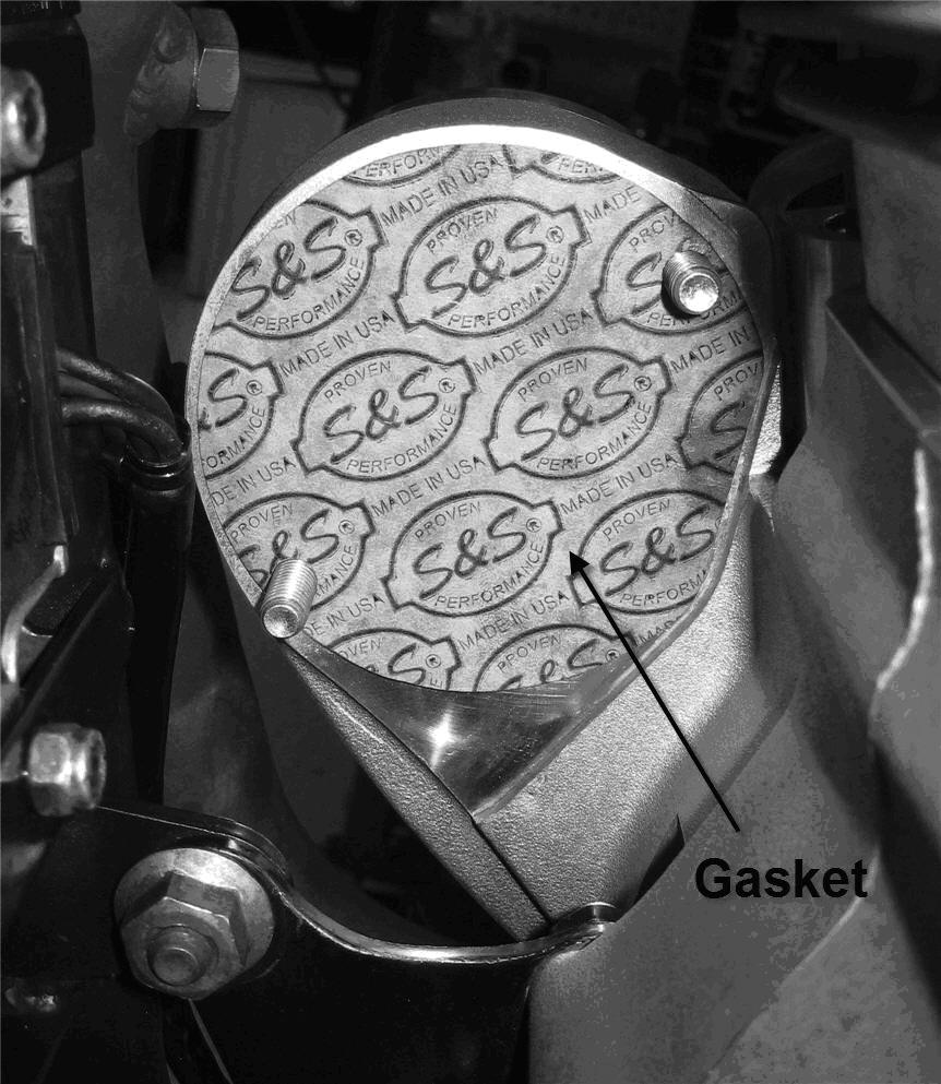 15- Place the new gasket provided in the kit between the filter mount and the crankcase, aligning its features with the filter mount facing the S&S logo outward. See Picture 12.