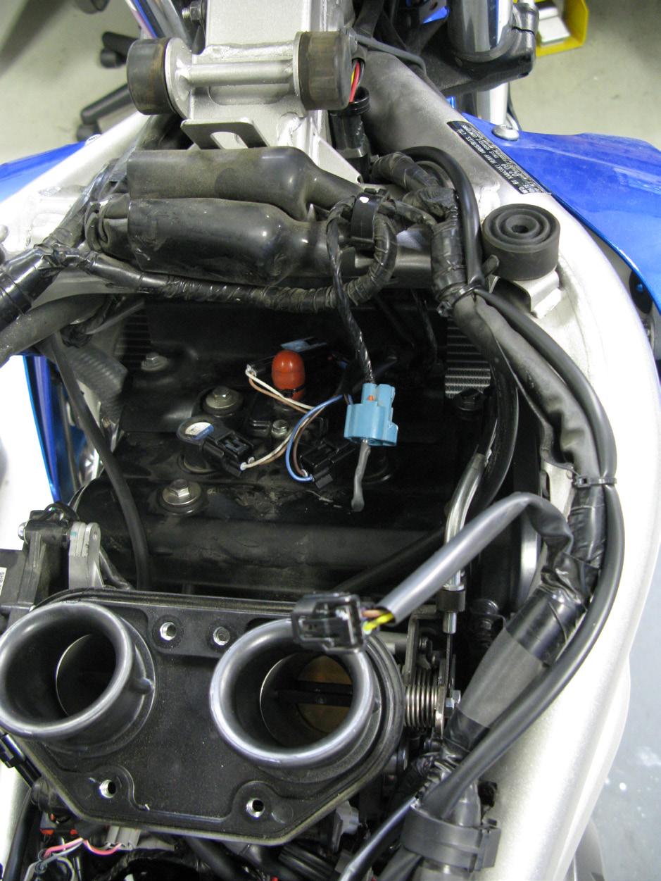 11. Now connect the Bazzaz coil harness main to the control unit and begin routing it to the front of the motorcycle following the same route as the fuel harness and continuing along the factory