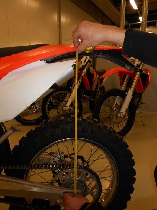 Determine the static sag of the shock absorber: Place the motorcycle on a flat piece of ground Ask a helper to hold the motorcycle Pull up the back of the motorcycle a few times to get the shock