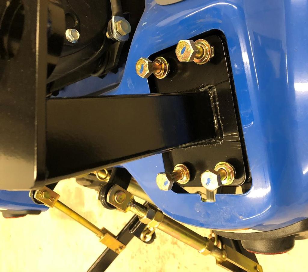 . Take the wider flasher light bracket and position onto the left rear bracket, the bent end will be on the outside. Use the remaining two factory ROPS fasteners for the two bolts.