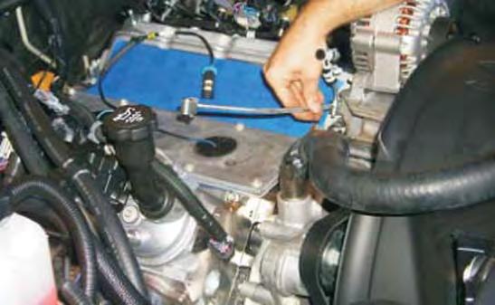 Using a 10mm socket wrench remove the two coolant vent
