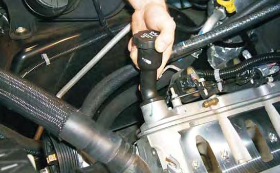 77. Remove the long oil fi ller neck from the valve cover by rotating it