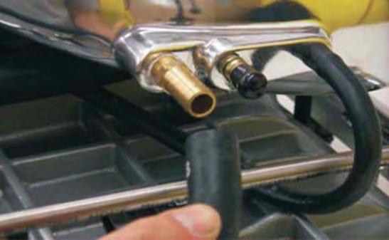 89. Install the power brake hose and clamp removed in the previous step to the large hose barb