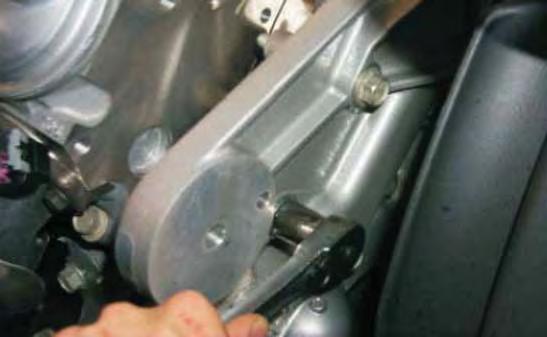 105. In the original tensioner location, install the new tensioner support bracket