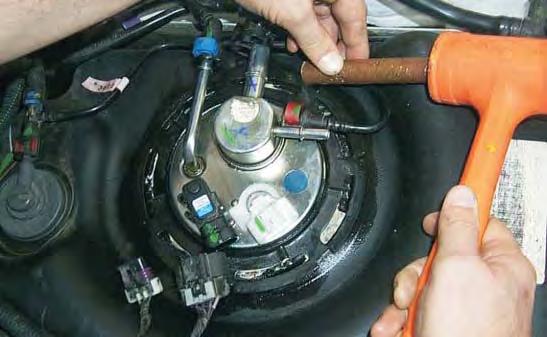 USE A NON METALLIC HAM- MER OR DRIFT to remove the lock ring by tapping the ring