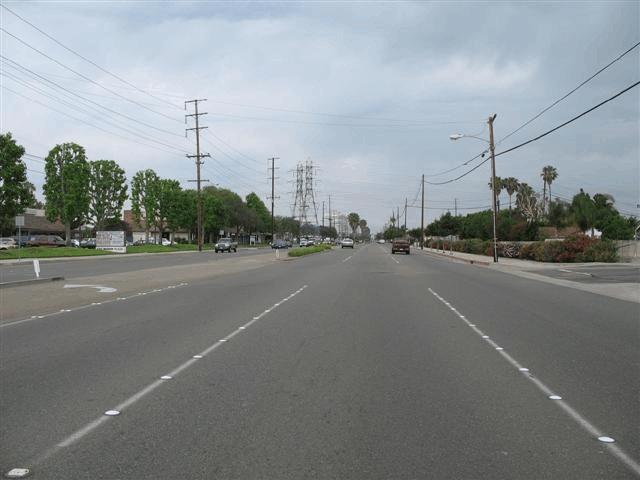 The west leg of the intersection was comprised of three eastbound through lanes, a left turn lane, a curbed median, and three westbound travel lanes (Figure 3).