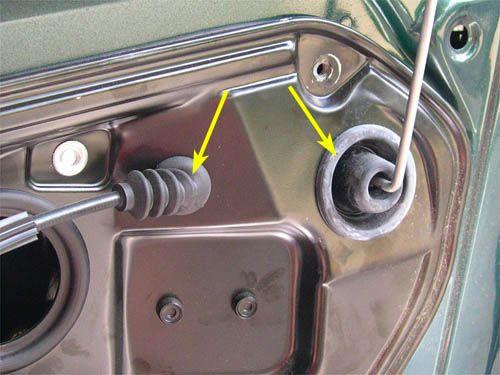 Behind the plastic tab is a retaining screw that is used to secure the lock cylinder or blank in the door handle, indicated by the yellow arrow in the picture below.