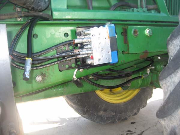 Hose Connection Procedure 13. Tighten all fittings with a 15/16 wrench. 14. Route both hoses along the existing right steer line up between the frame and the engine. 15. Route the hoses out over the top of the frame and back towards the Steering Valve.