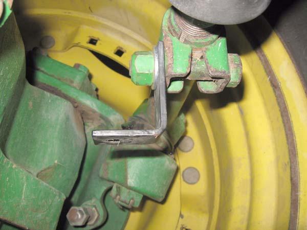 Remove the nut on the tie rod clamp with a 24 mm socket and ratchet and wrench. 6. Attach the linkage bracket to the tie rod clamp.