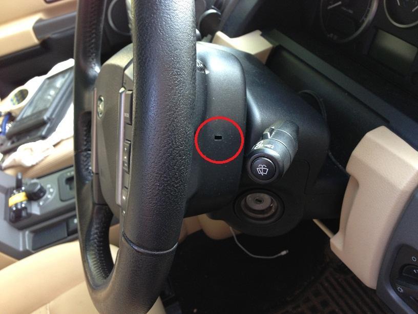 Once you can feel it hooked on, give it a pull and the airbag will start to pop out from the steering wheel.