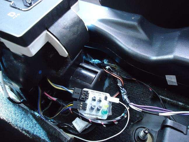 On the right side of this photo you can see the 4 long two wire cable that connects the shifter board to the main board mounted on the TCM. Run this cable along the console between the two boards.