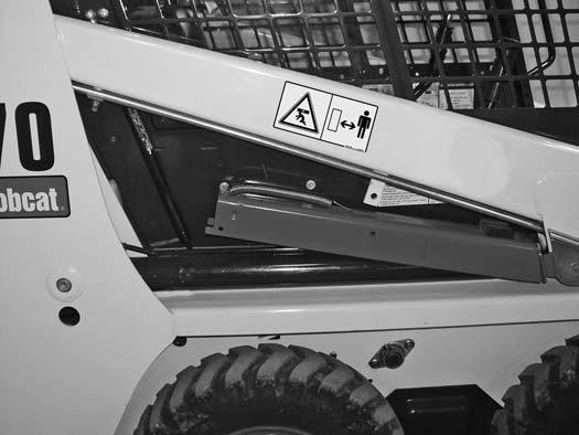 W-204-0895 Figure 89 Never work on a machine with the lift arms up unless the lift arms are secured by an approved lift arm support device.