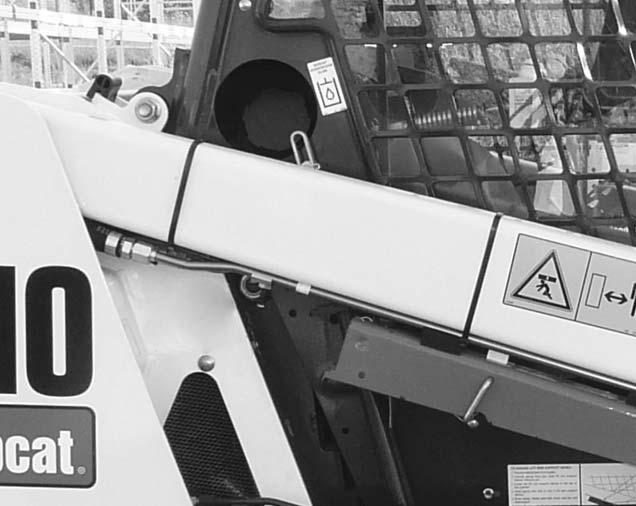 Park the loader on a level surface, lower the lift arms and tilt the Bob-Tach fully back. Stop the engine.