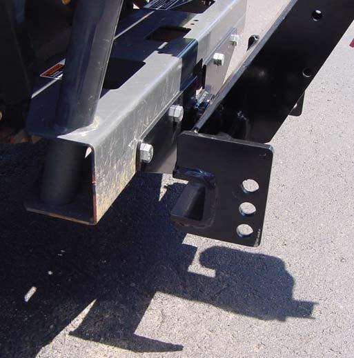 Place the stationary end of the Actuator between the plates of the Lift Arm as shown, line up holes and place 1/2 x 2 clevis pin in place