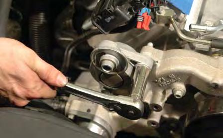 Use a 15mm wrench to remove the pulley from the tensioner