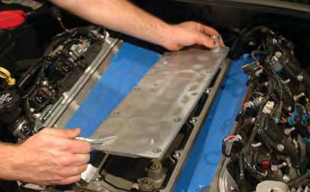 93. Use a 13mm socket wrench to remove the ten bolts that secure the engine valley