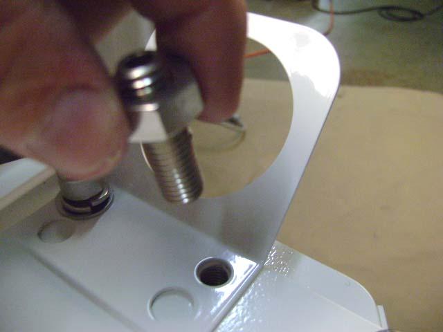 Place the Bracket for umbilical hose on top of the Swing Arm Rotation Plate and align the back/inside hole with threaded hole of Chair Mounting Plate underneath the slotted end of the Rotation Plate.