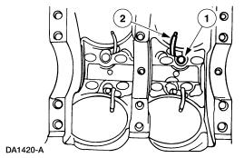 NOTE: All eight piston oil cooling jets are removed the same way.