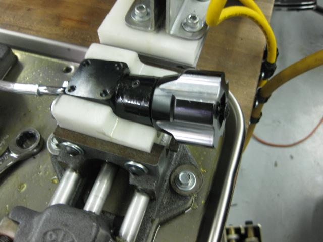 Using the end cap installation tooling, apply lock-tite to and torque the end cap (rotates clockwise, away from operator) to 45in/lbs. (Fig. 12) q.
