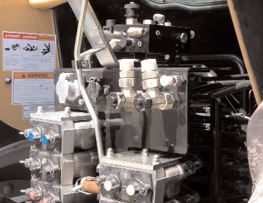The Automated Steering Block will receive pressure, tank, and load sense connections from the capped ports at the rear of the tractor, above the hydraulic remote valves. (Figure 3a.) b.