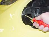 The passenger's side release lever is located along the side of the headlight housing. 2.