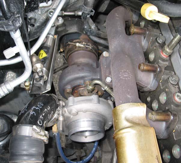 Remove the turbo oil feed line with a 13/16 wrench and the oil drain line with 10 mm socket. Pull the oil drain tube out of the engine block. Remove factory air box and intercooler tube.