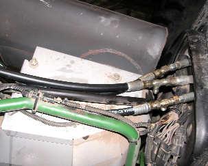Install hose (J) in place of the steel pressure line and insert run-tee (G) near the cab as shown.