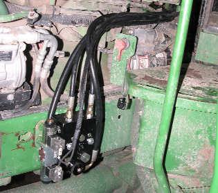 7. Install the Valve Control Cable: Route the valve control cable (O) from the hydraulic control block back behind the engine and across to the right side of the tractor. (Figure 7.