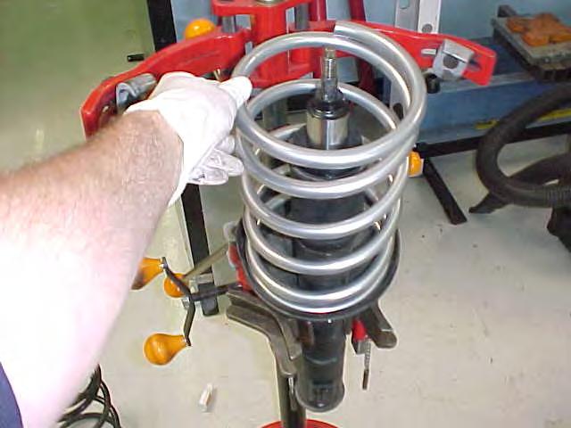 6. Place the new HT spring over the strut and repeat steps 5 to 2