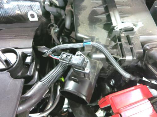 Remove the bolt that holds the factory air box in the engine compartment. h. Remove the factory intake from the vehicle.