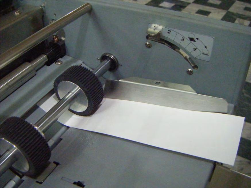 17.3 Place a 600gsm (2 x 300gsm) paper underneath the 2 side roller as shown below. Press the feed tray down and pull the paper to make sure the gap is right. It should not have too much drag. 17.