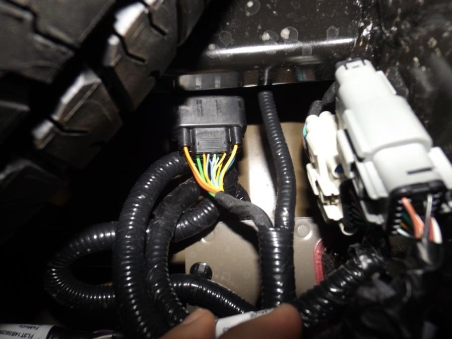 2. Disconnect the sensor harness plug, indicated by the red circle,