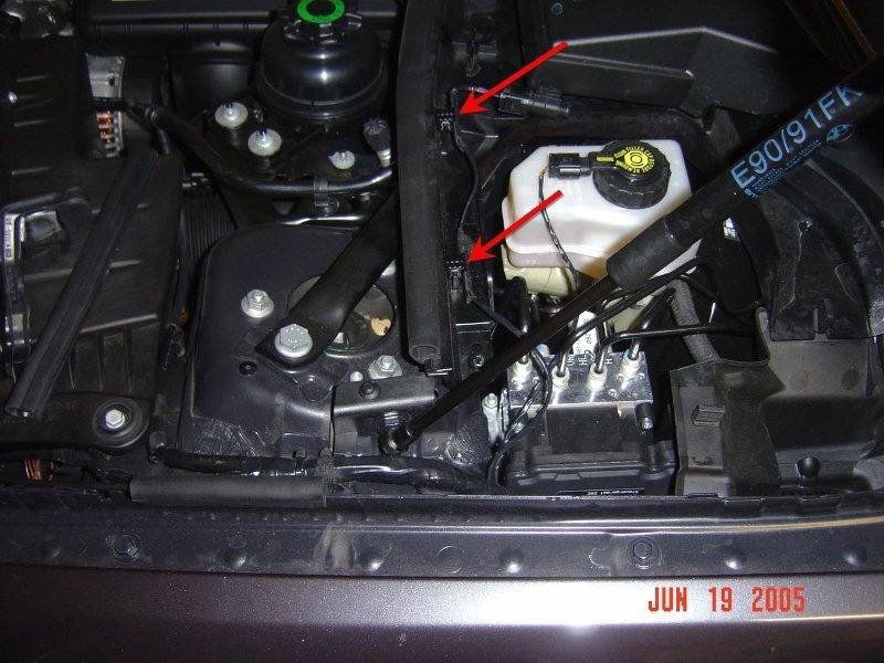 Once these pieces are removed, straighten out the hood switch wiring, and you will notice 2 plastic clips that are