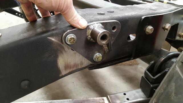 Now it's drill time. Use a 3/8" drill to drill out the rear hole for mounting the coil-over bracket. Then use a 5/8" bit to drill through the frame for the upper coil-over mount bolt.