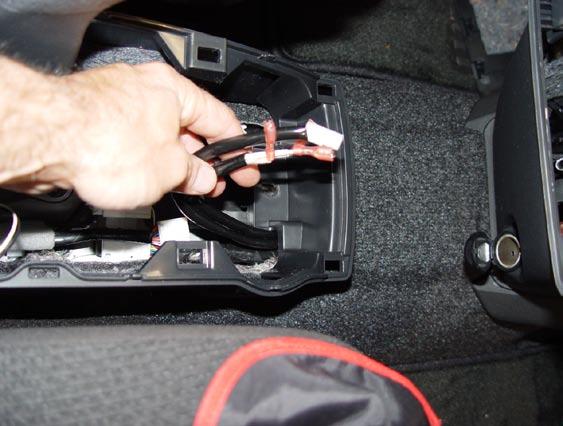 Replace lower half of center console, make sure the switch and cupholder leads are routed as shown. (Fig. G4) 7.
