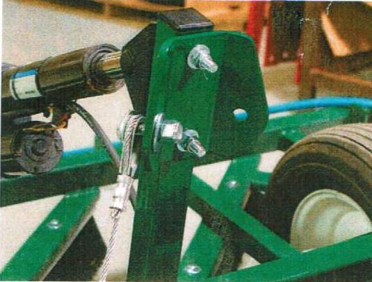 Attach the cable bracket to the upright arm of the wheel assembly on the Groomer.