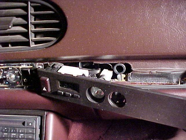 g. You should now be able to slide the clock, cigarette light, and hazard switch trim piece away from the dash. h. On the back of the trim panel disconnect the wires for the clock, cigarette lighter, and hazard switch.