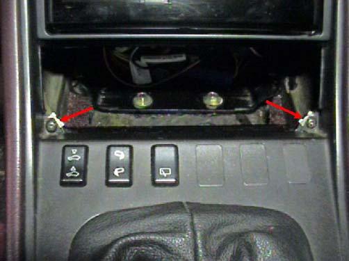 c. Remove the two Phillips head screws at the bottom of the pocket opening. d. Lift up on the console insert that surrounds the gear shift lever.