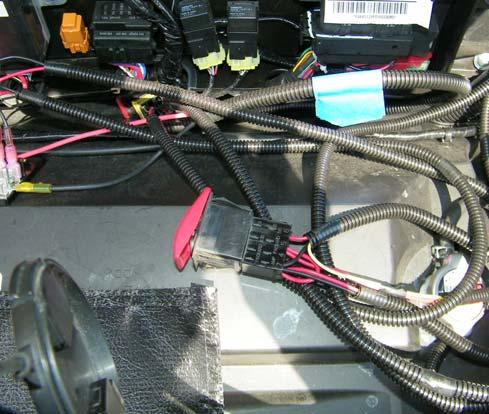 1 Under the hood, locate the section of the wire harness containing the red and yellow wires.