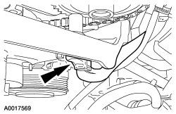 For additional information, refer to Section 211-02. 12. Remove the bolt and remove the belt tensioner.